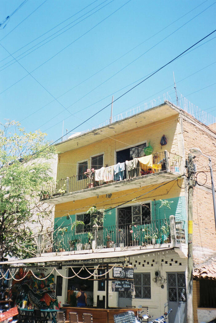 A home in Puerto Vallarta with a teal color and restaurant on the bottom
